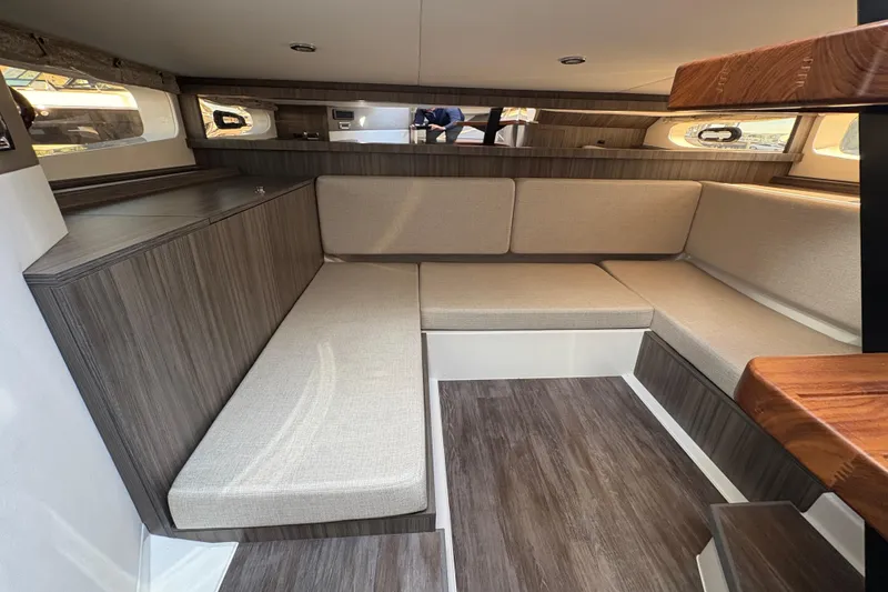 Slide: The Image of Interior of 2026 Sea Ray Sundancer 370 Outboard, featuring modern seating and wood finishes. - 20