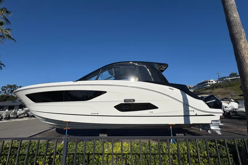 Slide: The Image of 2026 Sea Ray Sundancer 370 Outboard boat displayed outdoors on a sunny day. - 3