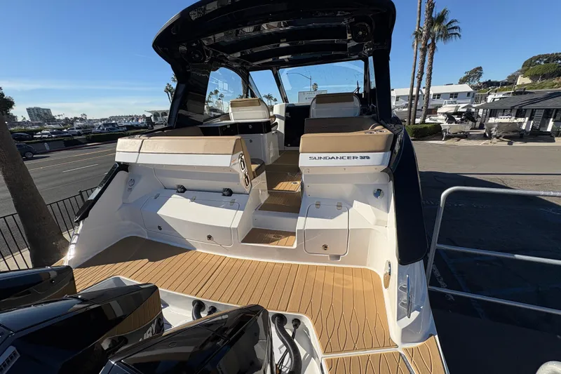 Slide: The Image of 2026 Sea Ray Sundancer 370 Outboard, rear view, docked with sleek design and spacious seating. - 6