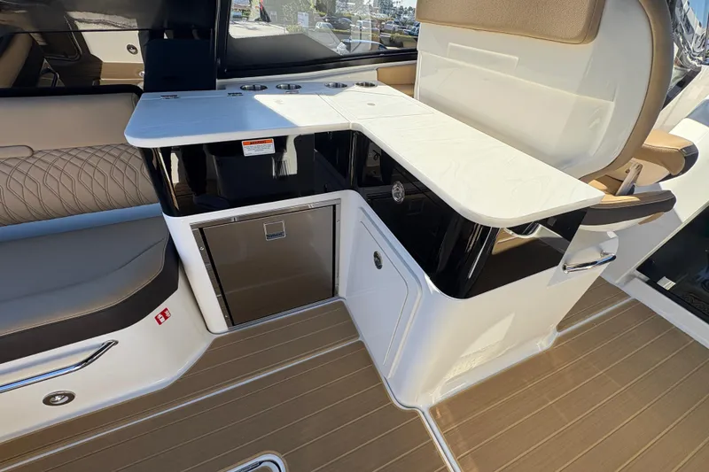 Slide: The Image of Interior of 2026 Sea Ray Sundancer 370 Outboard, featuring sleek seating and modern cabinetry. - 8