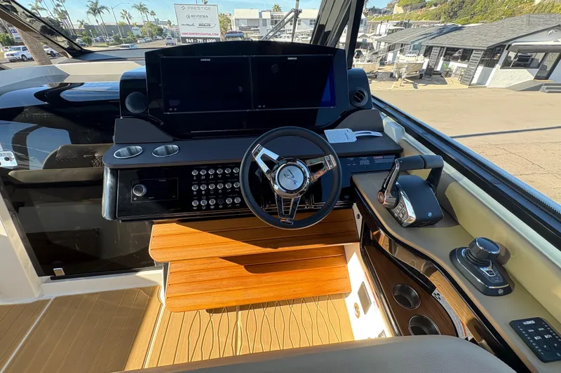 Slide: The Image of Helm of 2026 Sea Ray Sundancer 370 Outboard with modern controls and navigation system. - 9