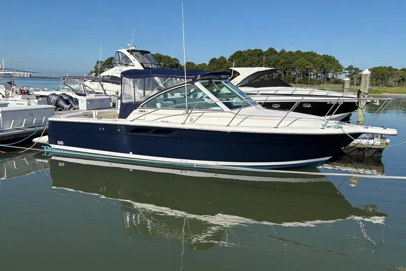 The Image of 2004 Tiara Yachts 2900 Coronet docked in a marina, surrounded by other boats. - 0