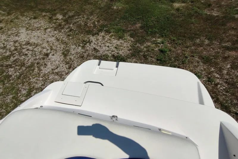 Slide: The Image of 2005 Rinker 232 Captiva Cuddy boat on grassy terrain, viewed from above. - 10