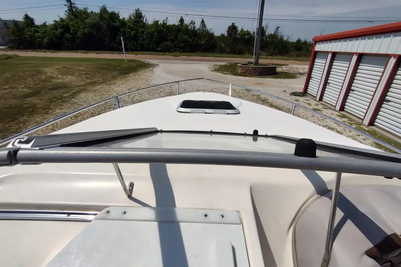 Slide: The Image of 2005 Rinker 232 Captiva Cuddy boat deck view near storage facility. - 18