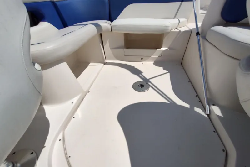 Slide: The Image of 2005 Rinker 232 Captiva Cuddy interior with white and blue seating. - 25