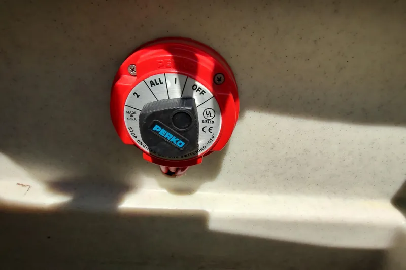 Slide: The Image of Battery switch on 2005 Rinker 232 Captiva Cuddy boat, featuring Perko brand. - 5