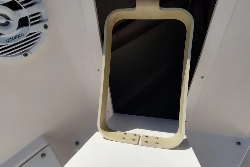 Slide: The Image of 2005 Rinker 232 Captiva Cuddy interior with Kenwood speaker and open hatch detail. - 6