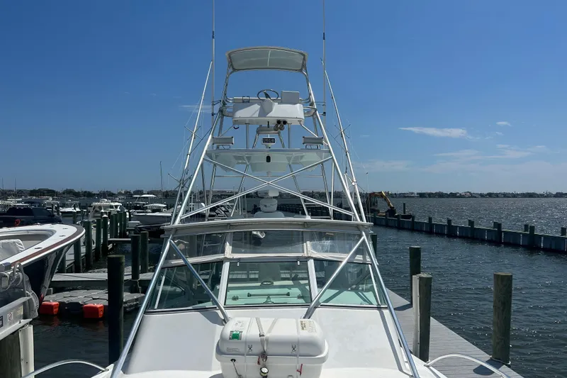 Slide: The Image of 2006 Topaz 40 Express yacht docked at marina under clear blue sky. - 25