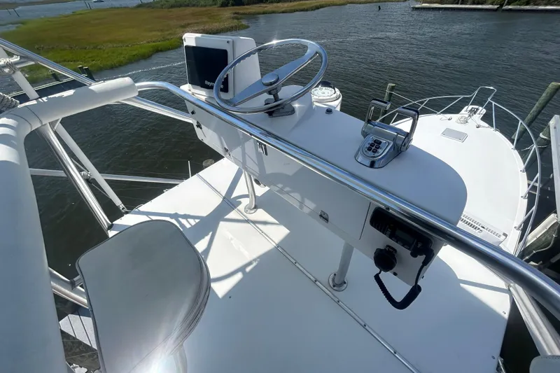 Slide: The Image of Helm of 2006 Topaz 40 Express boat with steering wheel and controls. - 27