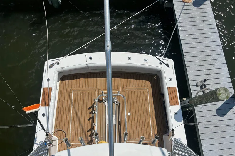 Slide: The Image of Top view of 2006 Topaz 40 Express yacht docked, showcasing teak deck and fishing equipment. - 29