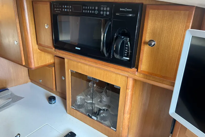 Slide: The Image of 2006 Topaz 40 Express kitchen with microwave, coffee maker, and wooden cabinetry. - 37