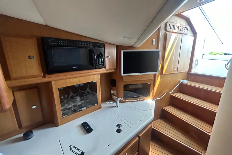 Slide: The Image of Interior of 2006 Topaz 40 Express yacht with kitchen and entertainment area. - 38