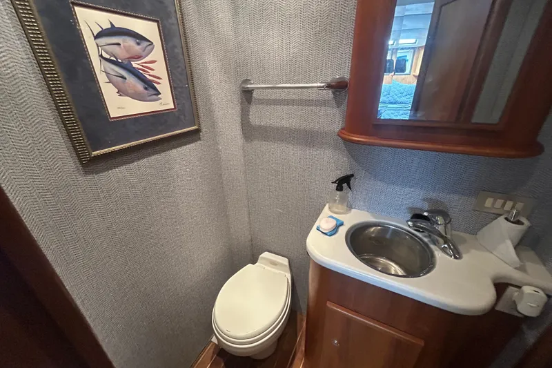 Slide: The Image of Bathroom interior of 2006 Topaz 40 Express yacht with sink, toilet, and fish artwork. - 41