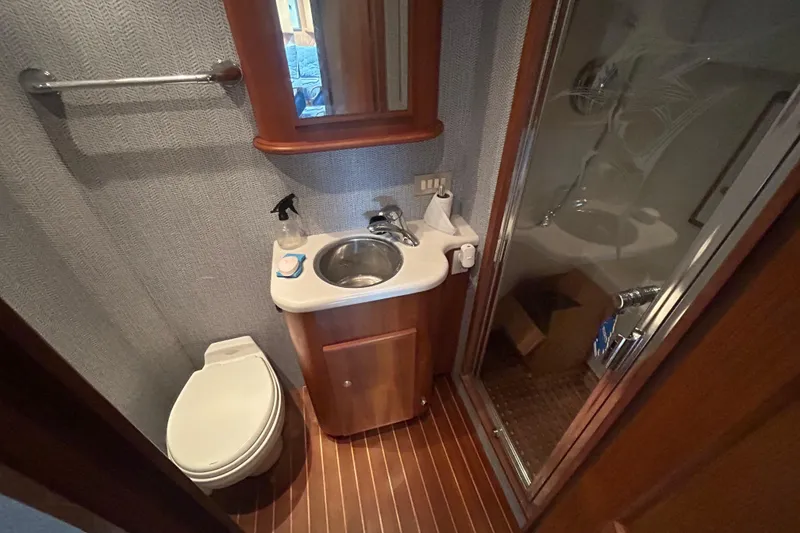 Slide: The Image of Luxurious 2006 Topaz 40 Express yacht bathroom with shower, sink, and toilet. - 43