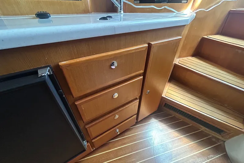 Slide: The Image of Wooden cabinetry and stairs inside a 2006 Topaz 40 Express boat interior. - 45