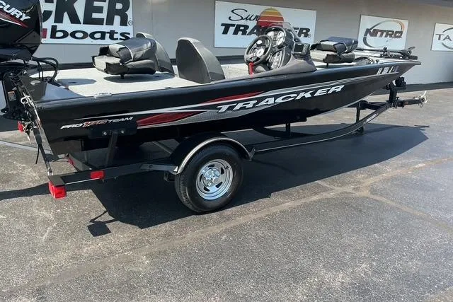 Slide: The Image of 2022 Bass Tracker PRO TEAM 175 TXW boat on trailer, displayed outdoors. - 3