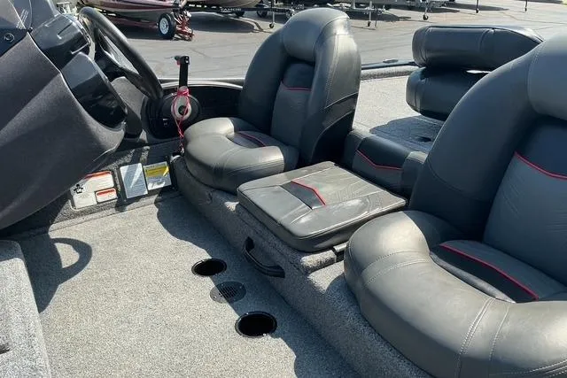 Slide: The Image of 2022 Bass Tracker PRO TEAM 175 TXW interior with gray seating and steering wheel. - 4