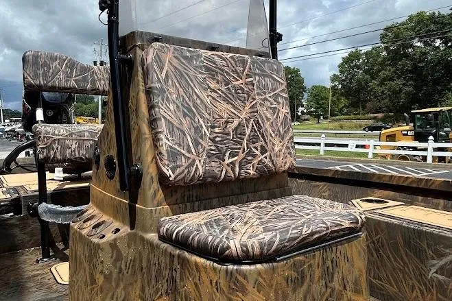 Slide: The Image of 2025 G3 Bay 19 GX Tunnel boat with camouflage seating and console, outdoors. - 8