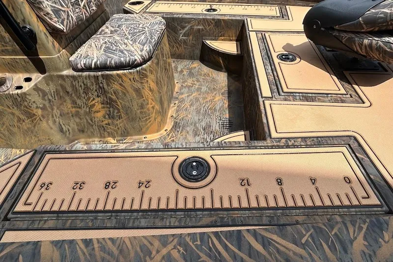 Slide: The Image of 2025 G3 Bay 19 GX Tunnel boat interior with camo design and integrated measuring ruler. - 9
