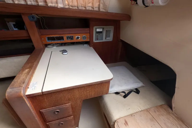 Slide: The Image of 1976 Ranger 33 sailboat interior with navigation desk and control panel. - 15