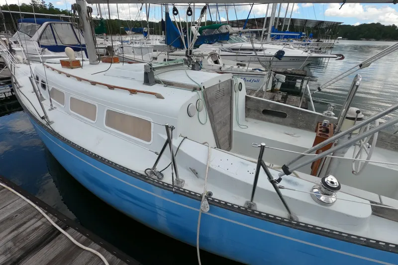Slide: The Image of 1976 Ranger 33 sailboat docked at marina, featuring blue and white hull. - 2
