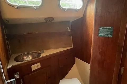 Slide: The Image of 1976 Ranger 33 boat interior with sink and wooden cabinetry. - 23