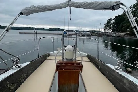 Slide: The Image of 1976 Ranger 33 sailboat deck view at a marina with calm waters. - 6
