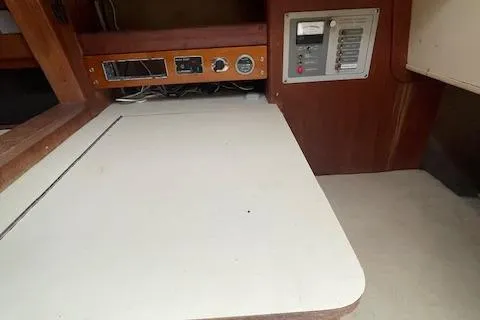 Slide: The Image of 1976 Ranger 33 interior with control panel and wooden cabinetry. - 16