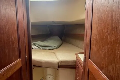 Slide: The Image of Interior cabin of a 1976 Ranger 33 sailboat with wooden finish and cozy sleeping area. - 20