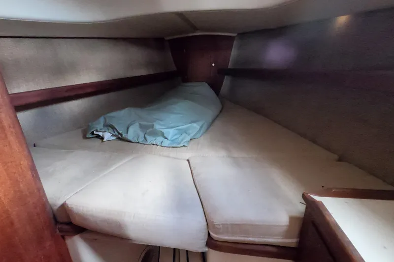 Slide: The Image of Cozy cabin interior of a 1976 Ranger 33 sailboat with cushioned sleeping area. - 21
