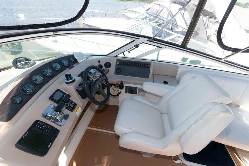 Slide: The Image of 2005 Carver 360 Mariner helm with steering wheel, gauges, and white captain's chair. - 10
