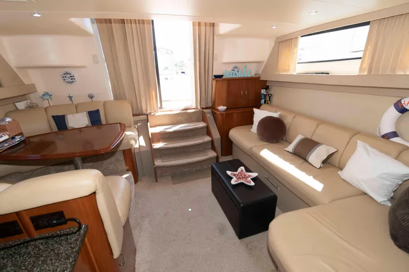 Slide: The Image of Luxurious interior of 2005 Carver 360 Mariner yacht with beige seating and nautical decor. - 15