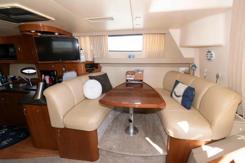 Slide: The Image of Interior of 2005 Carver 360 Mariner yacht with cozy seating and dining area. - 16
