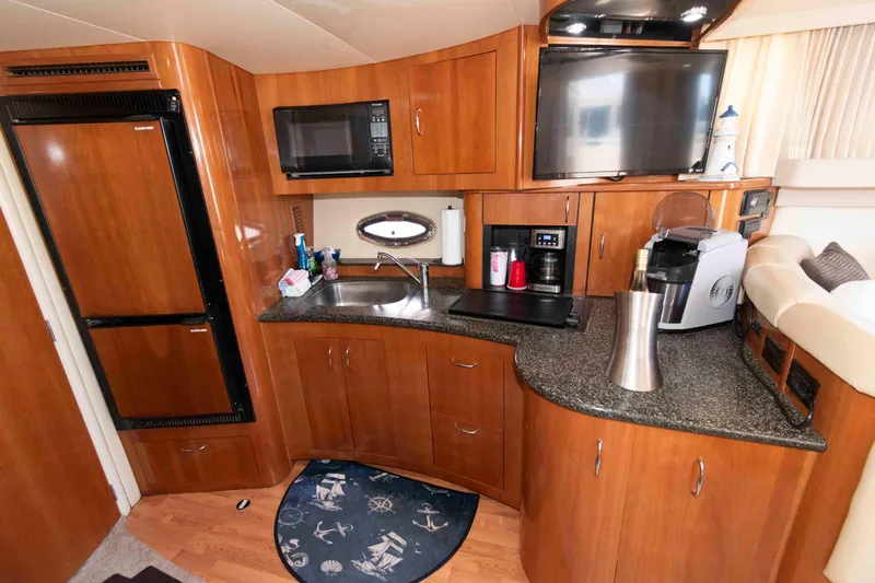 Slide: The Image of 2005 Carver 360 Mariner yacht kitchen with wood cabinetry, appliances, and countertop. - 17