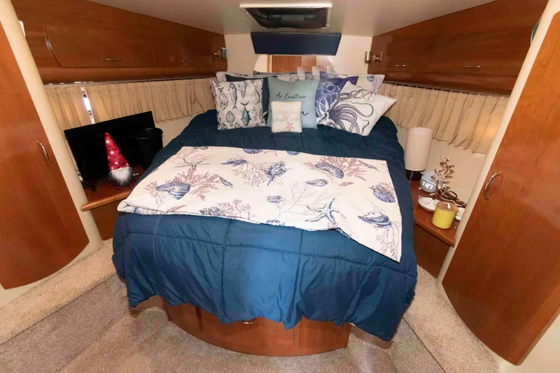 Slide: The Image of Cozy bedroom in 2005 Carver 360 Mariner yacht with nautical-themed bedding and decor. - 18
