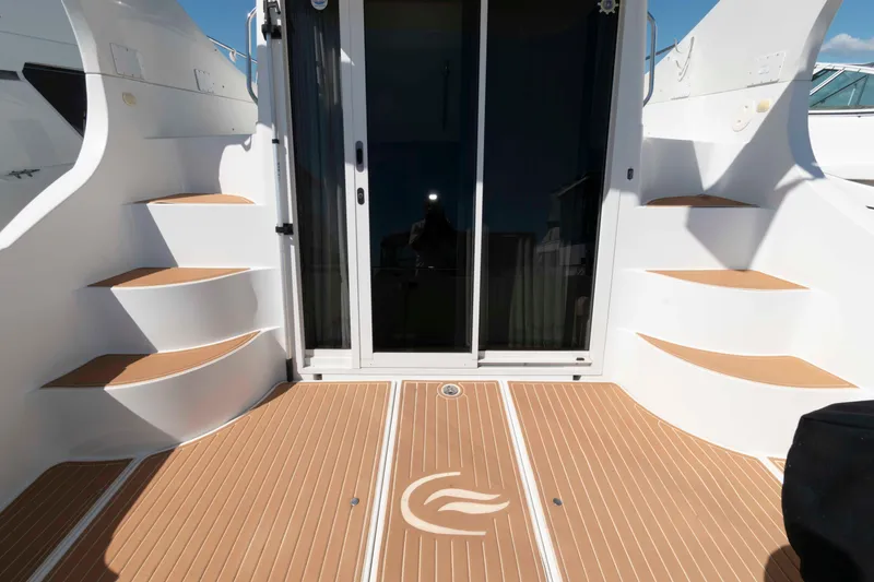 Slide: The Image of 2005 Carver 360 Mariner yacht deck with stairs and sliding glass door. - 2