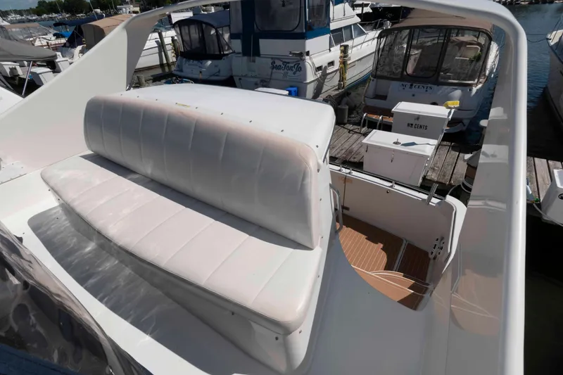 Slide: The Image of 2005 Carver 360 Mariner yacht with cushioned seating at a marina. - 5