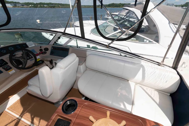 Slide: The Image of 2005 Carver 360 Mariner yacht interior with steering wheel and white seating. - 8