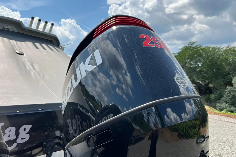 Slide: The Image of Suzuki 250 outboard motor on 2021 Hewescraft 220 Ocean Pro ET boat under cloudy sky. - 11