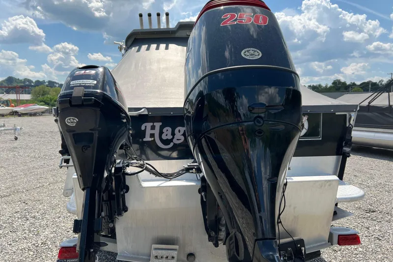 Slide: The Image of 2021 Hewescraft 220 Ocean Pro ET with dual outboard motors, parked outdoors. - 12