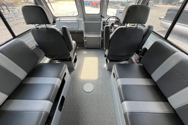 Slide: The Image of Interior of 2021 Hewescraft 220 Ocean Pro ET boat, featuring seating and steering area. - 15