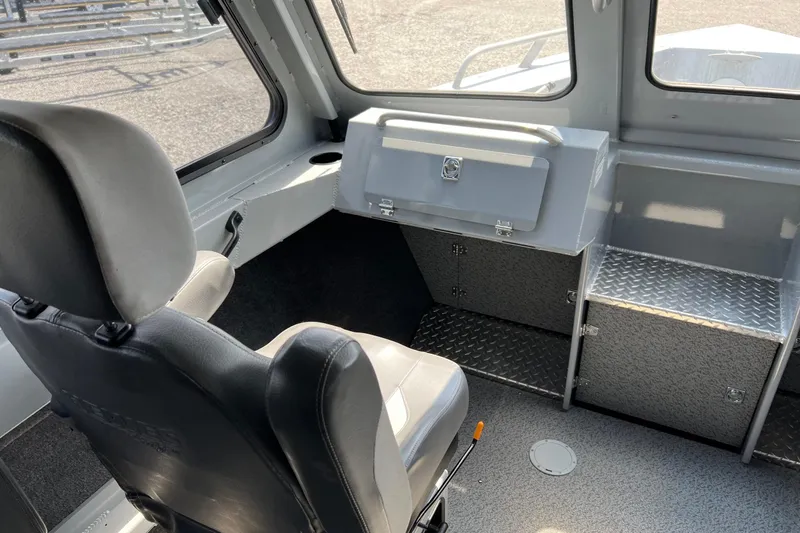 Slide: The Image of Interior of 2021 Hewescraft 220 Ocean Pro ET boat, featuring seating and storage compartments. - 18