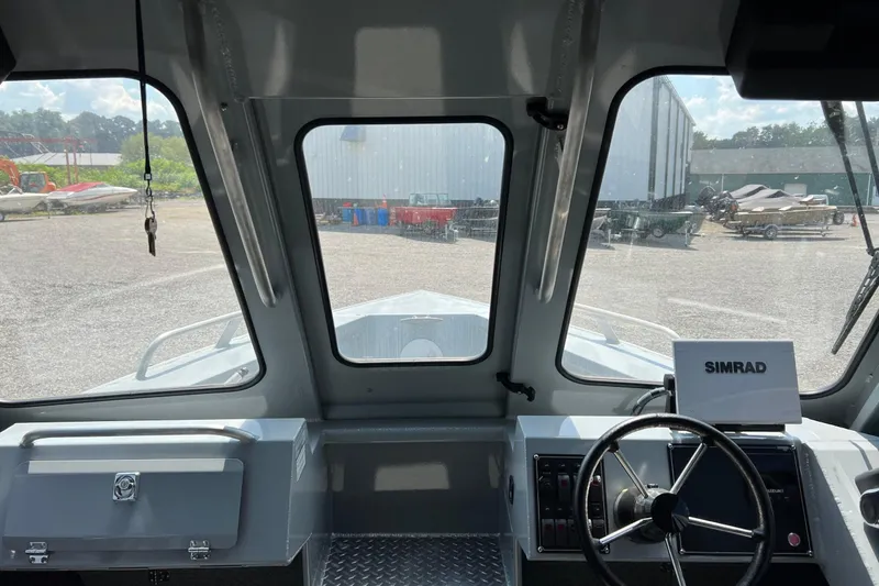 Slide: The Image of Interior view of 2021 Hewescraft 220 Ocean Pro ET boat cockpit with Simrad navigation system. - 19