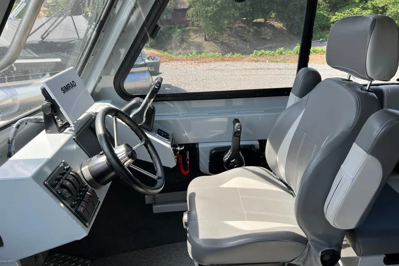 Slide: The Image of Interior of 2021 Hewescraft 220 Ocean Pro ET boat with steering wheel and controls. - 22