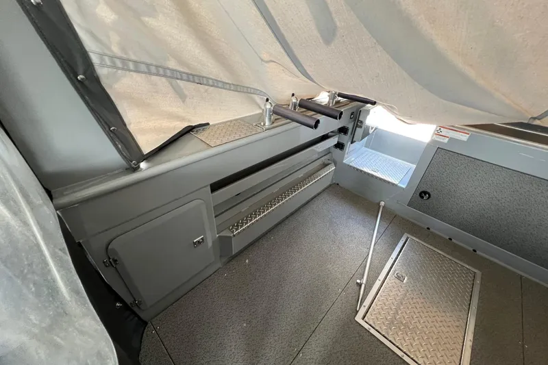 Slide: The Image of 2021 Hewescraft 220 Ocean Pro ET interior with storage compartments and rod holders. - 28