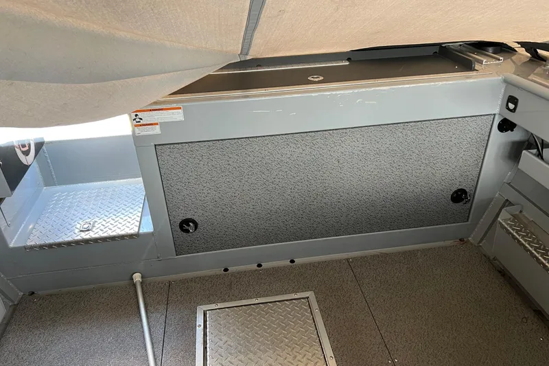 Slide: The Image of Interior of 2021 Hewescraft 220 Ocean Pro ET boat, featuring storage compartments and non-slip flooring. - 32