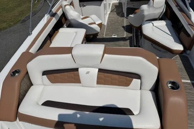 Slide: The Image of 2018 Four Winns HD220 OB boat interior with white and brown seating, cup holders, and spacious layout. - 5