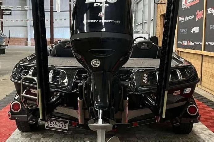 Slide: The Image of 2018 Ranger Z520C boat with powerful engine, displayed indoors on checkered flooring. - 3