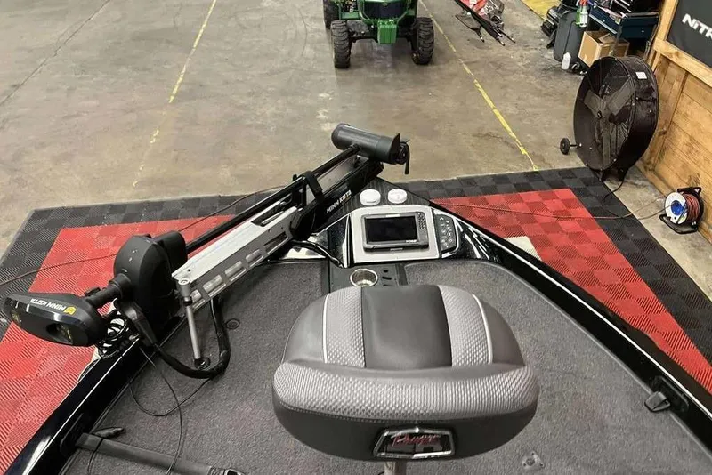 Slide: The Image of 2018 Ranger Z520C boat interior with trolling motor and control panel in a garage setting. - 7