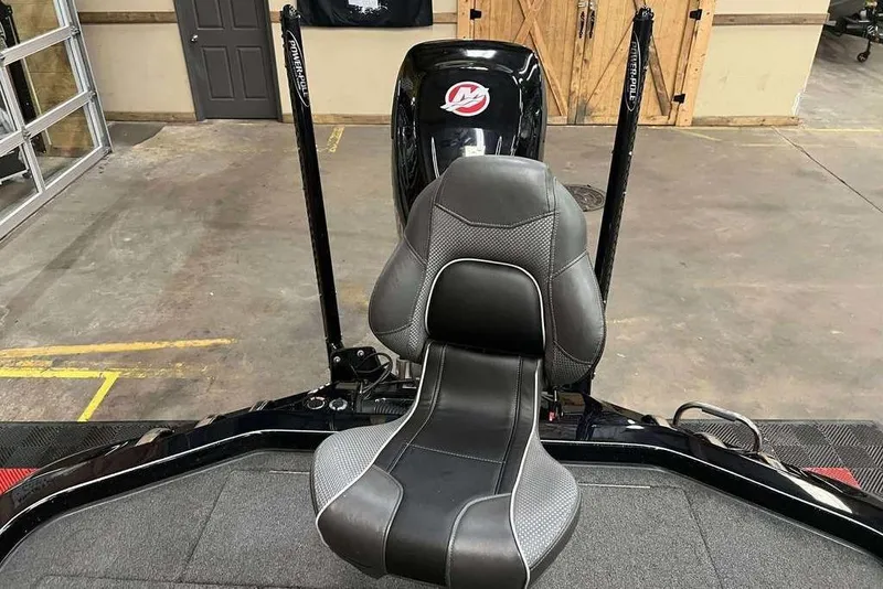 Slide: The Image of 2018 Ranger Z520C boat interior with a sleek black and gray seat in a garage setting. - 8